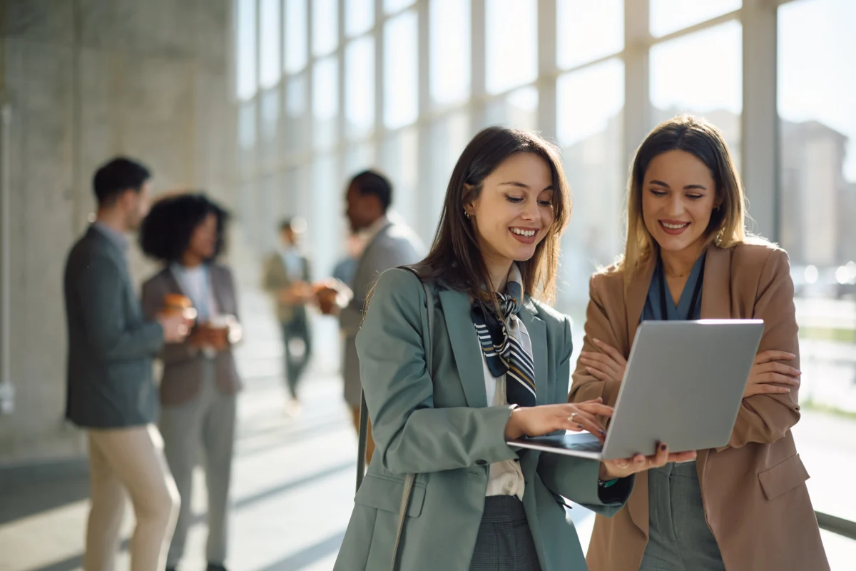 happy-businesswomen-using-laptop